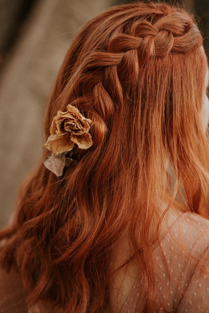 Flower Braided into Womans Red Hair